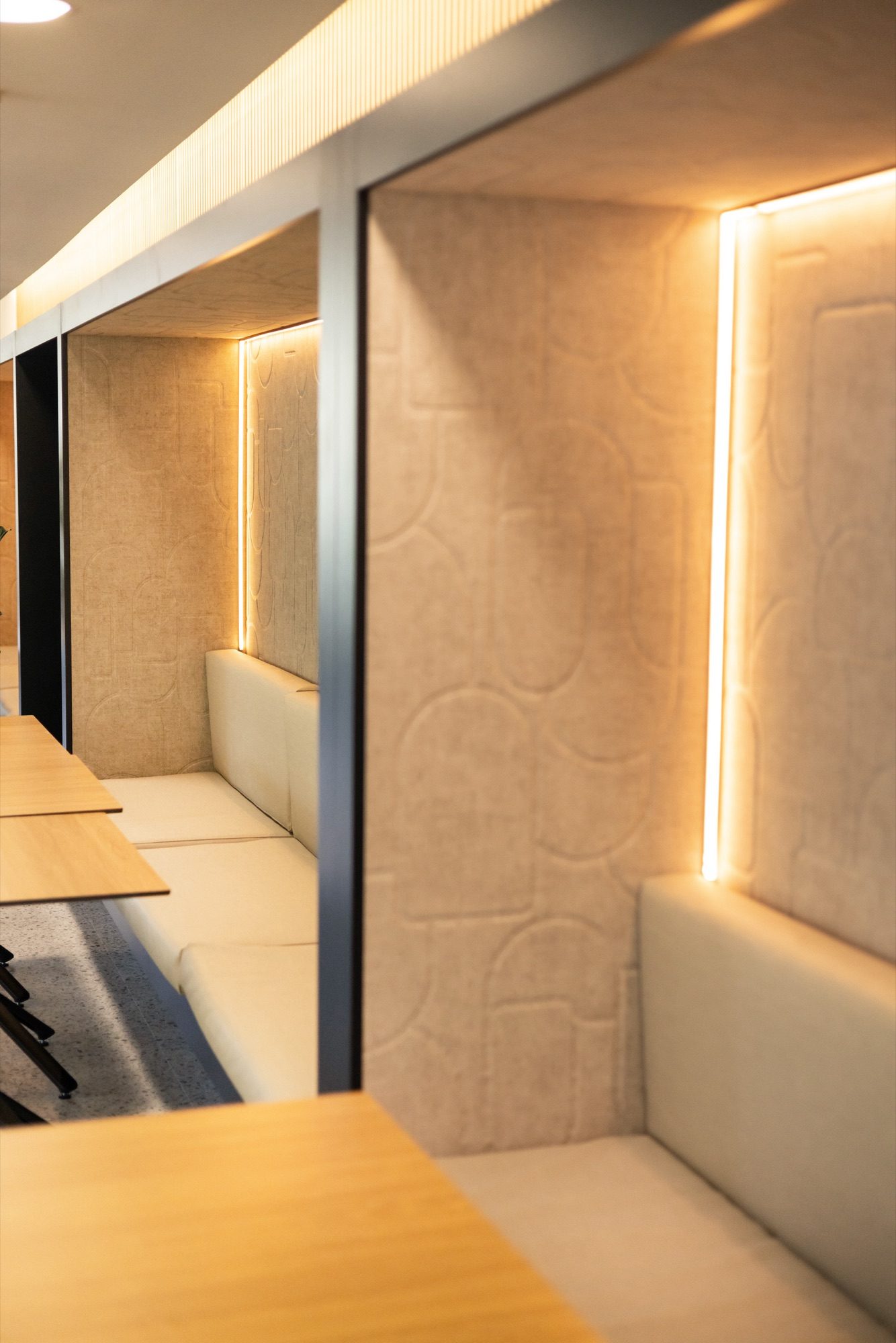 Alcôves de travail à panneaux acoustiques crème en relief, rétroéclairées