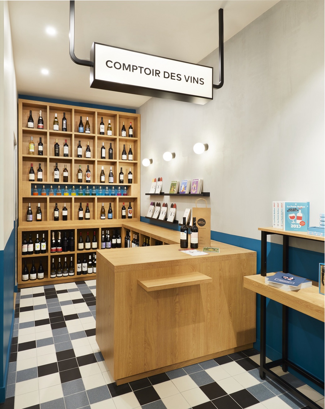 Comptoir des vins en bois sur mesure et sol à damier de la boutique Le Petit Ballon, agencé par Isospace