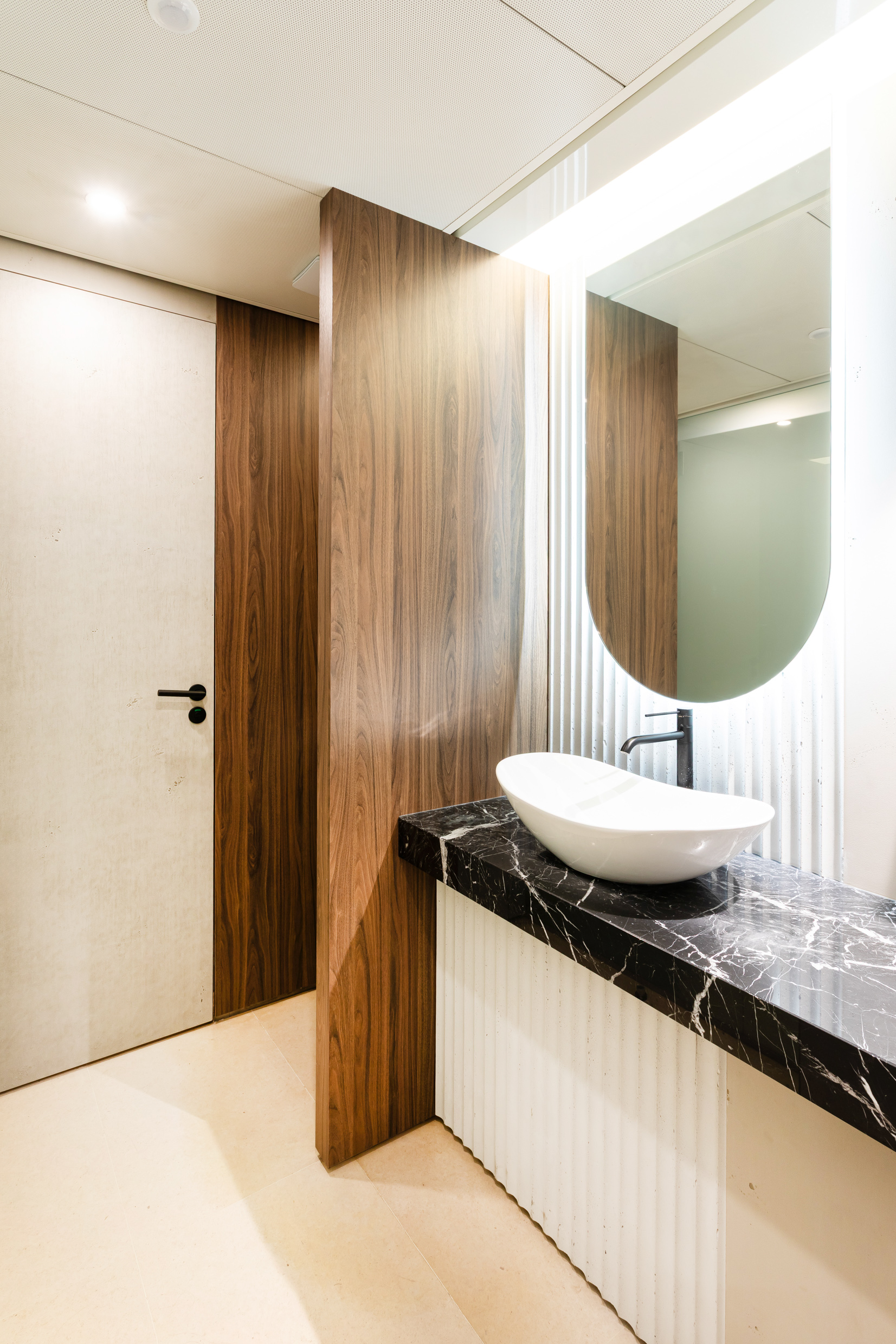 Sanitaires habillés de marbre noir et travertin, vasque design