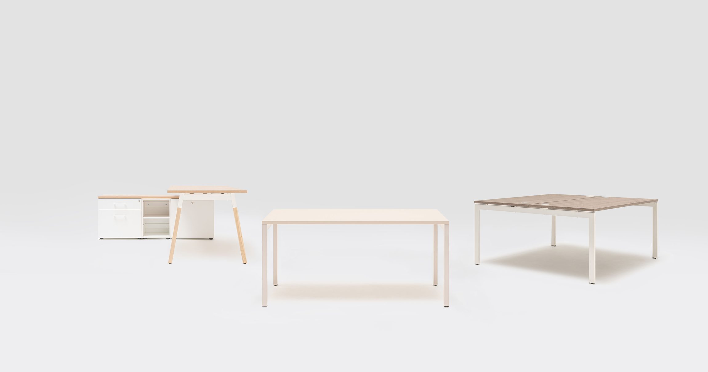 Gamme Ogi alignée sur fond blanc : caisson, bureau à piètement bois et table, mobilier MDD