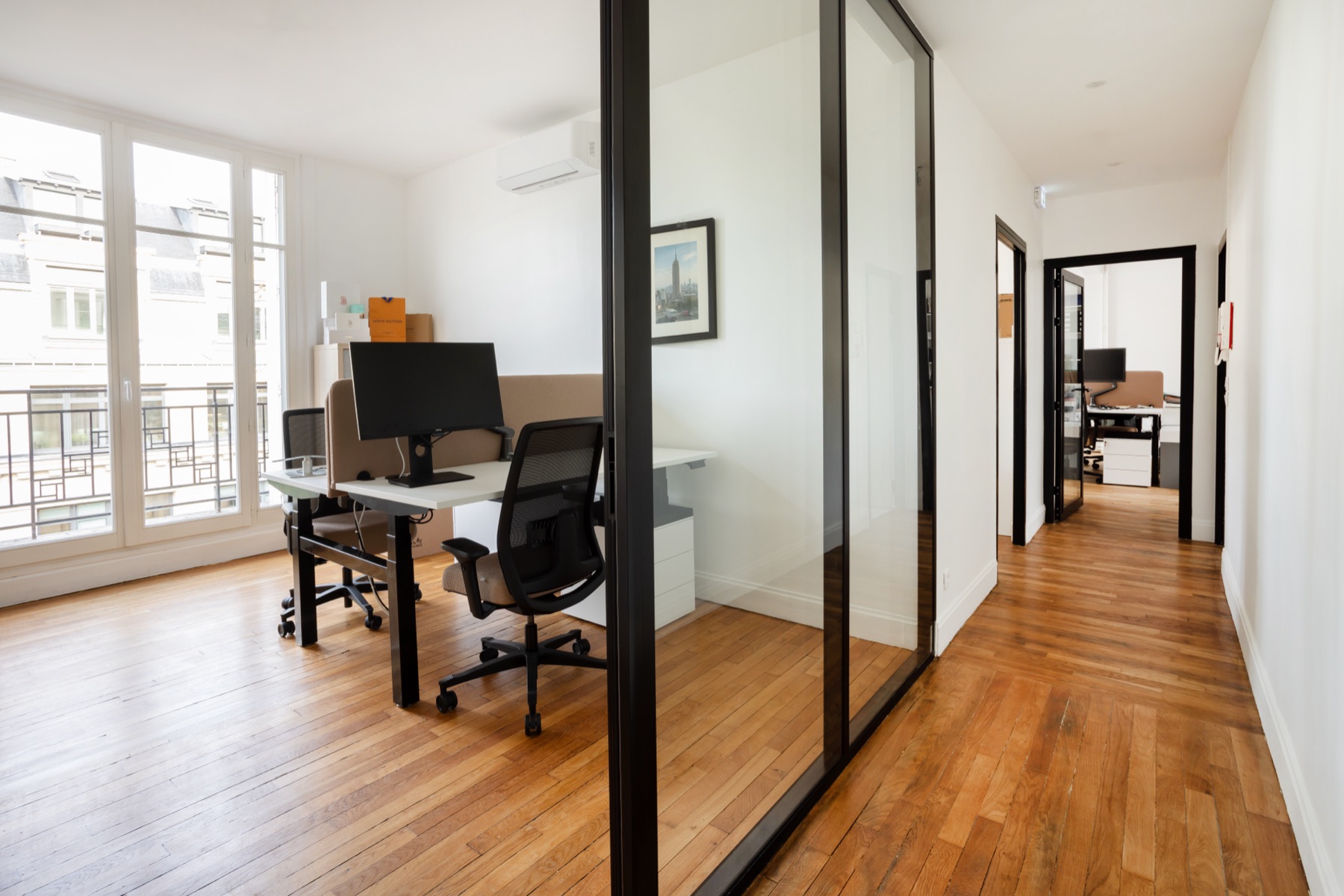 Cloison vitrée en acier noir entre un bureau et le couloir, bureaux Act Beauty